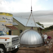 Crane is used to lift dome in place